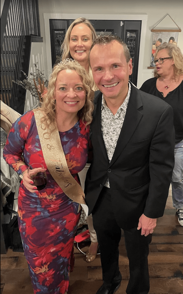 David Farr posing with guests at an event