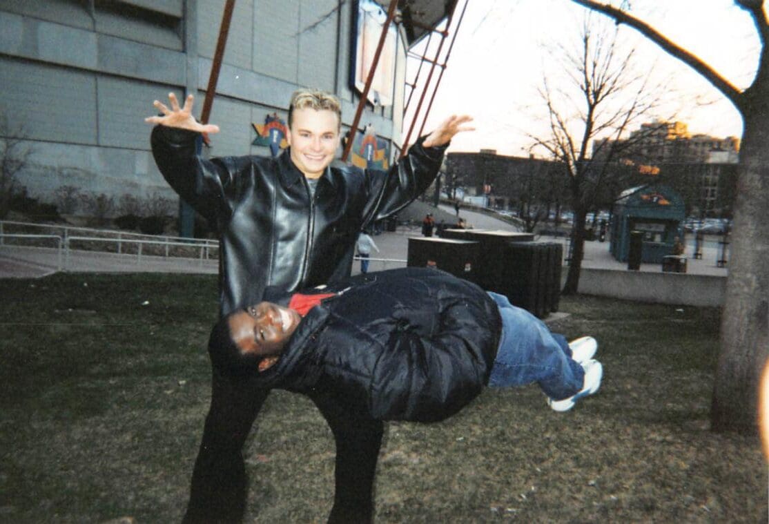 David Farr levitating a volunteer outside the Metrodome David Farr outside the Metrodome with both hands raised, appearing to levitate a man in a winter coat horizontally in mid-air
